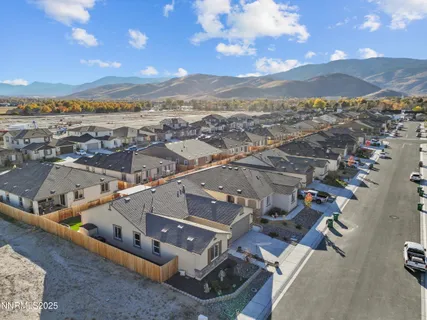 an aerial view of a house with a mountain