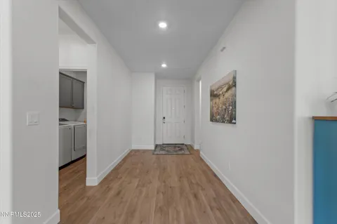 a view of hallway with wooden floor