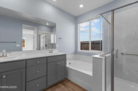 a bathroom with a tub sink shower and mirror