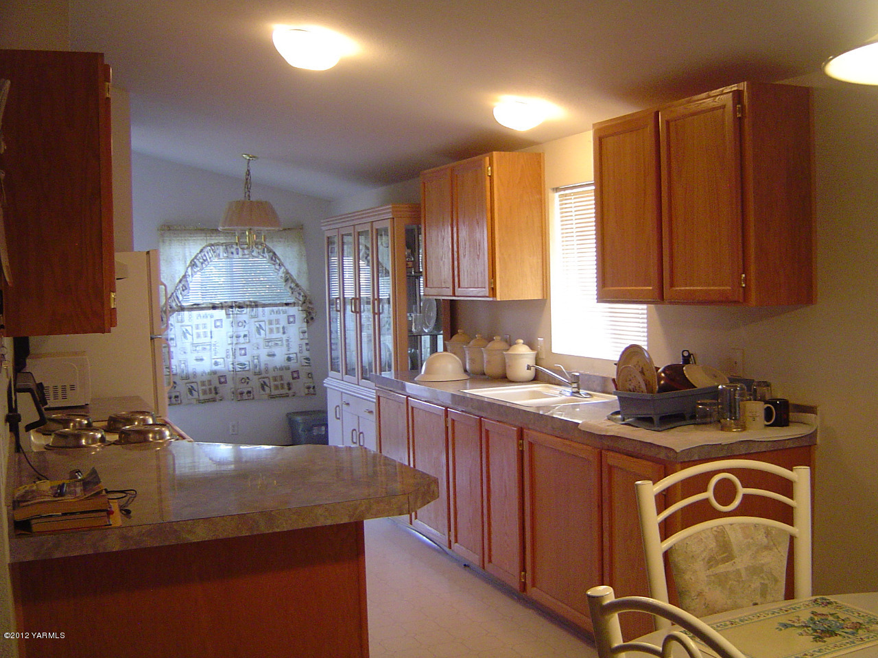 2810 Birchfield Road Yakima, WA 98901 - Photo 12 of 14 a kitchen with a sink a stove cabinets and a window