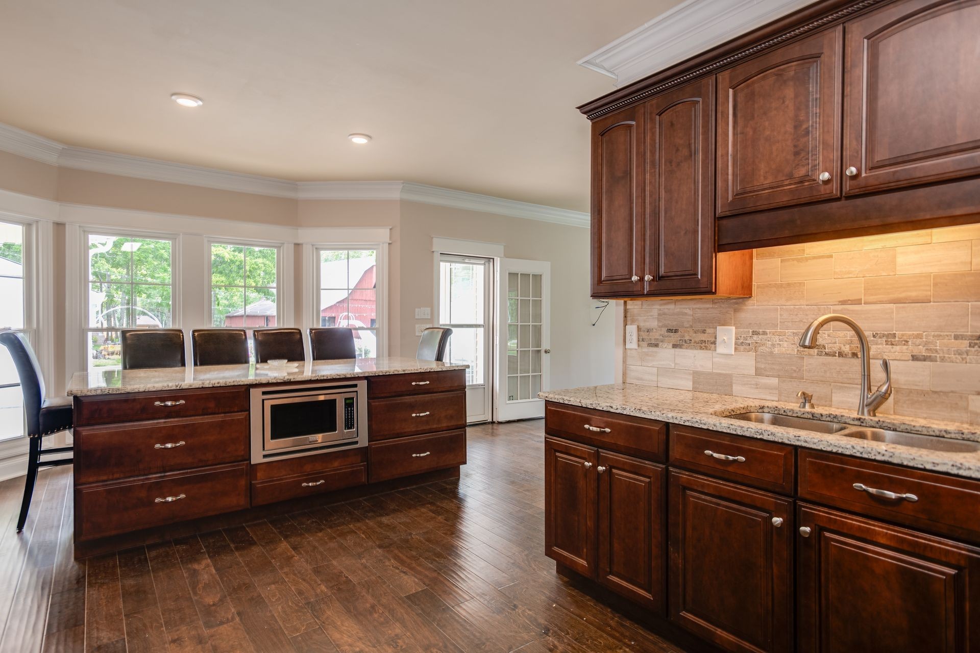 8712 Link Road Christiana, TN 37037 - Photo 14 of 65 a kitchen with stainless steel appliances kitchen island granite countertop wooden cabinets and a sink