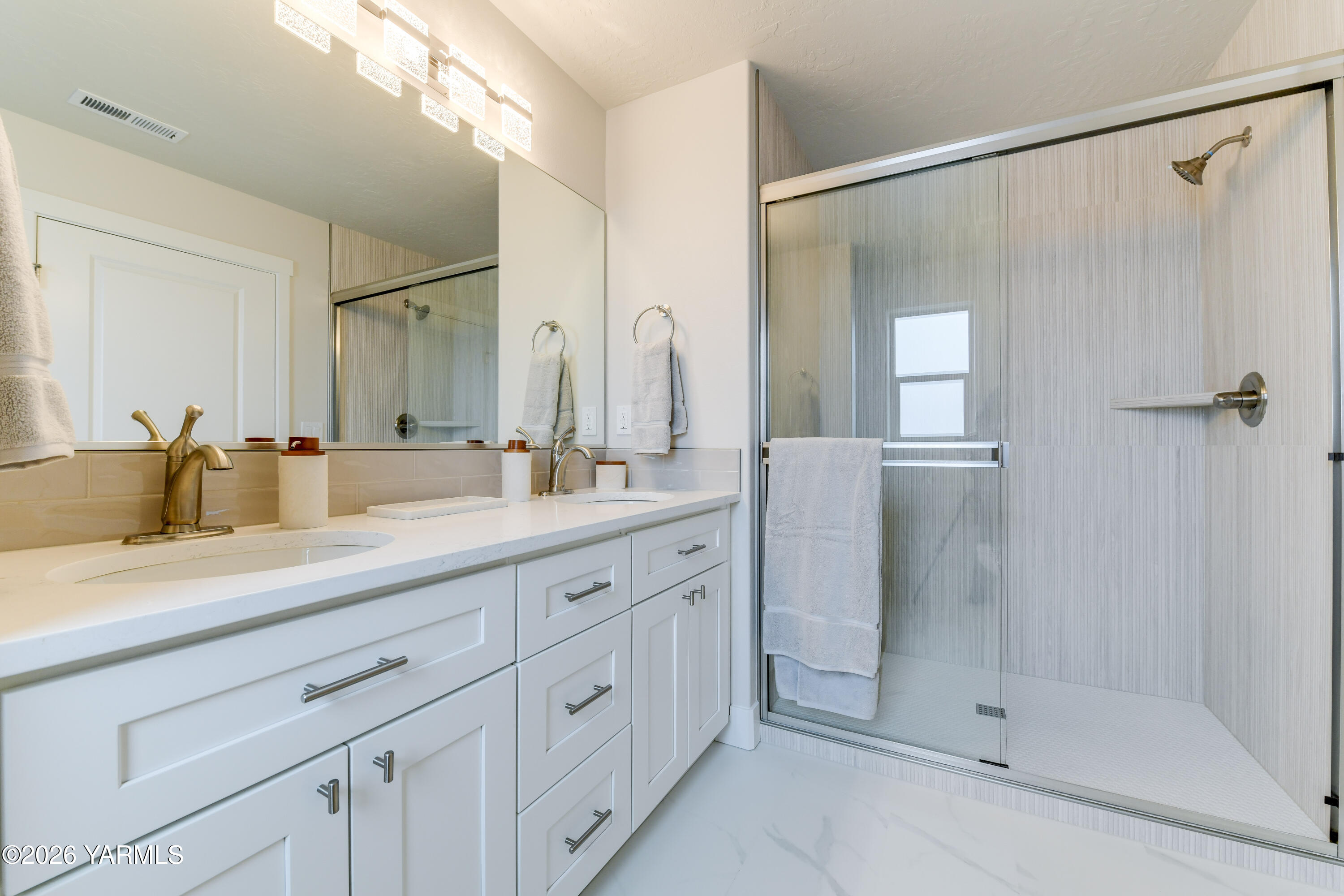 903 North Euclid Road, Unit PHASE 1 LOT 8) SPEC Grandview, WA 98930 - Photo 22 of 25 a spacious bathroom with a shower sink and mirror