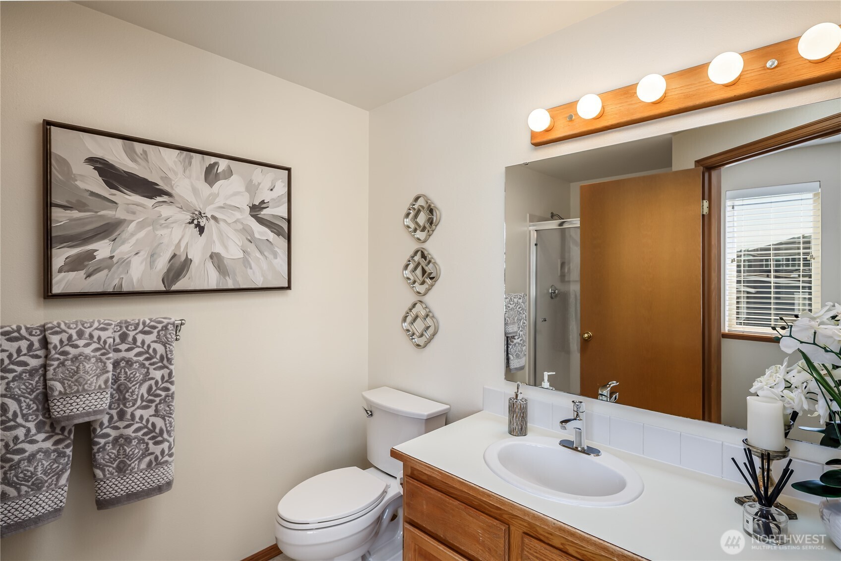 610 Glen Street, Unit 3 Edmonds, WA 98020 - Photo 15 of 19 a bathroom with a toilet a sink and a mirror