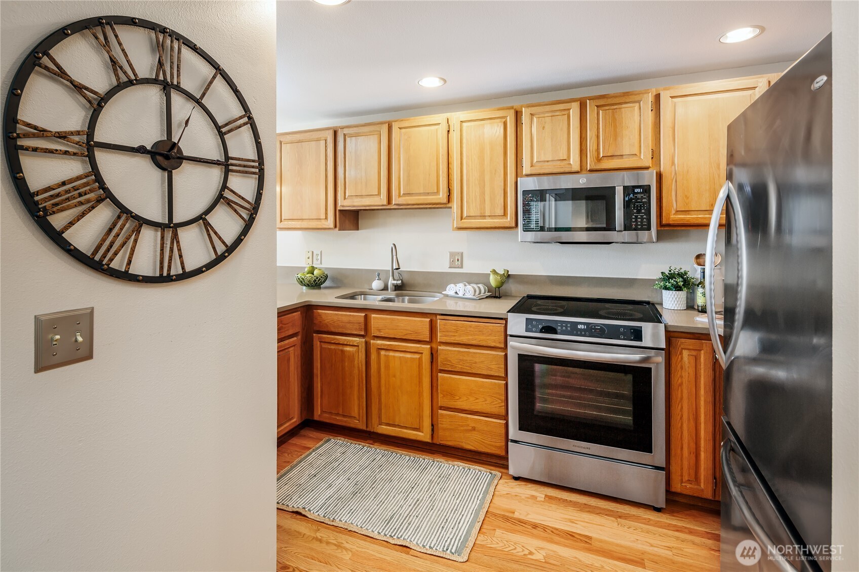 610 Glen Street, Unit 3 Edmonds, WA 98020 - Photo 7 of 19 a kitchen with stainless steel appliances granite countertop a stove a microwave and a refrigerator