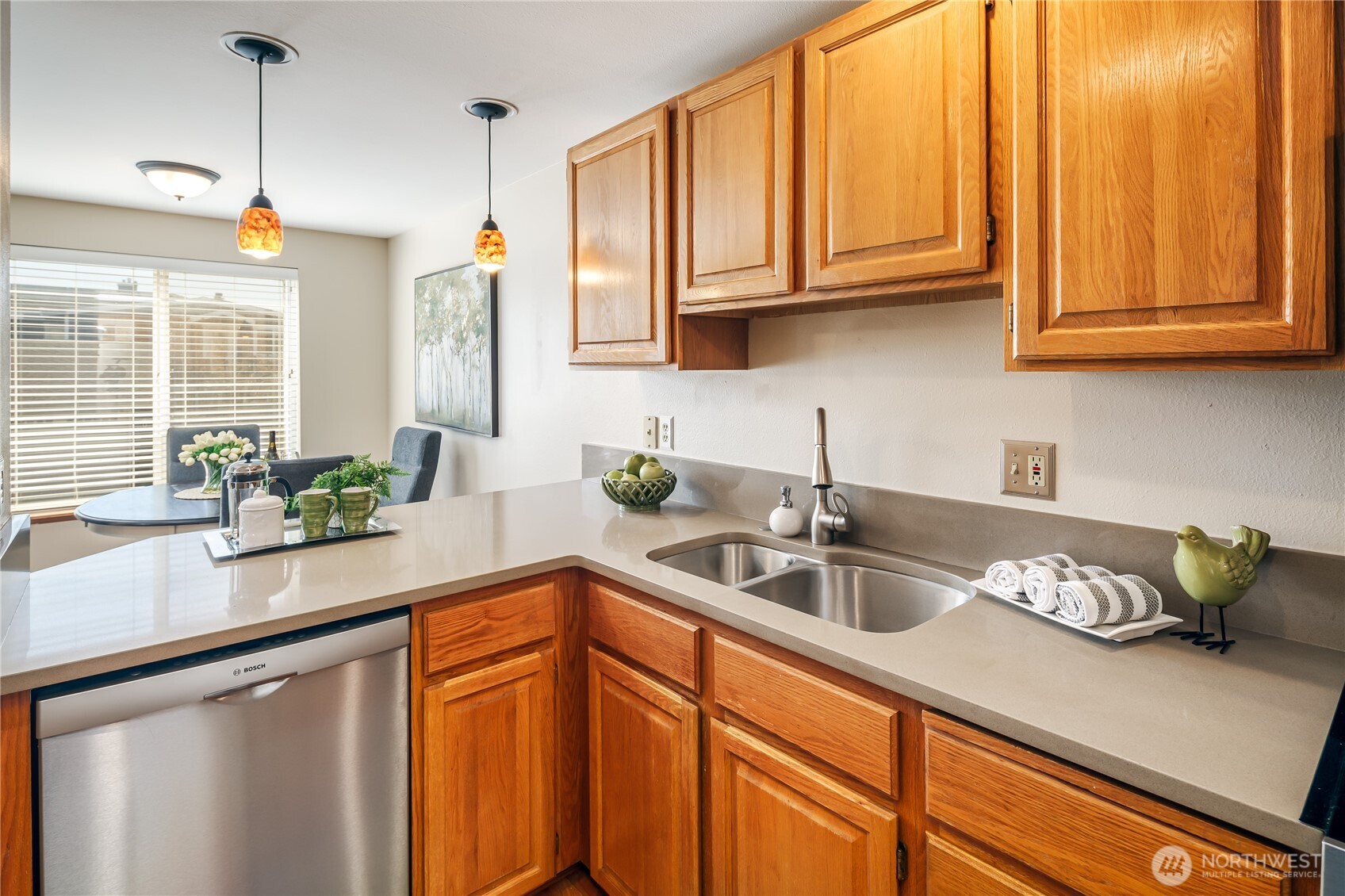 610 Glen Street, Unit 3 Edmonds, WA 98020 - Photo 8 of 19 a kitchen with stainless steel appliances granite countertop a sink a counter space and cabinets