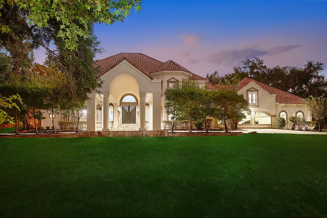 a view of a big yard with a house in the background