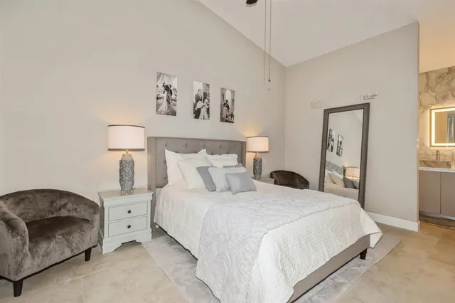 a bedroom with a bed and a lamp