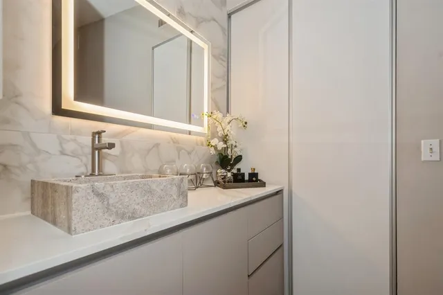 a bathroom with a sink and mirror