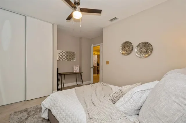 a bedroom with a bed and a table