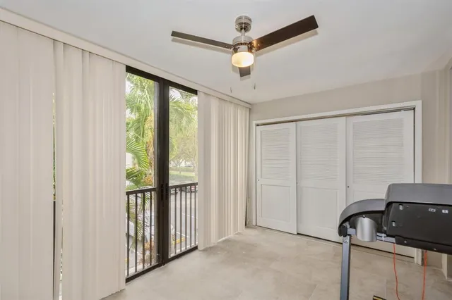 a view of a livingroom with a ceiling fan and a large window