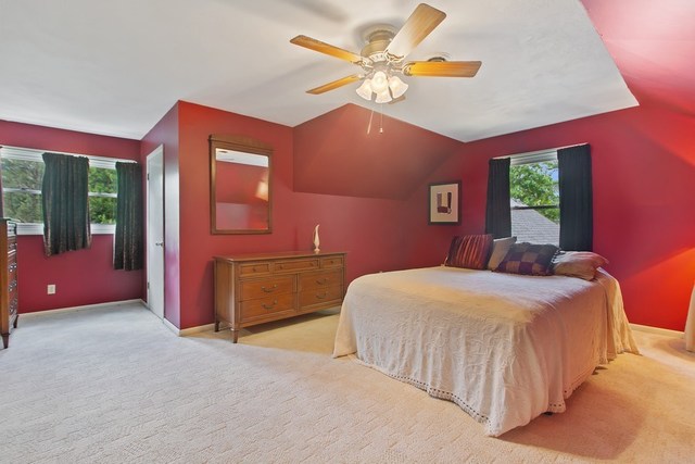 1870 Scully Road Dwight, IL 60420 - Photo 19 of 29 a bedroom with a large bed and a chandelier
