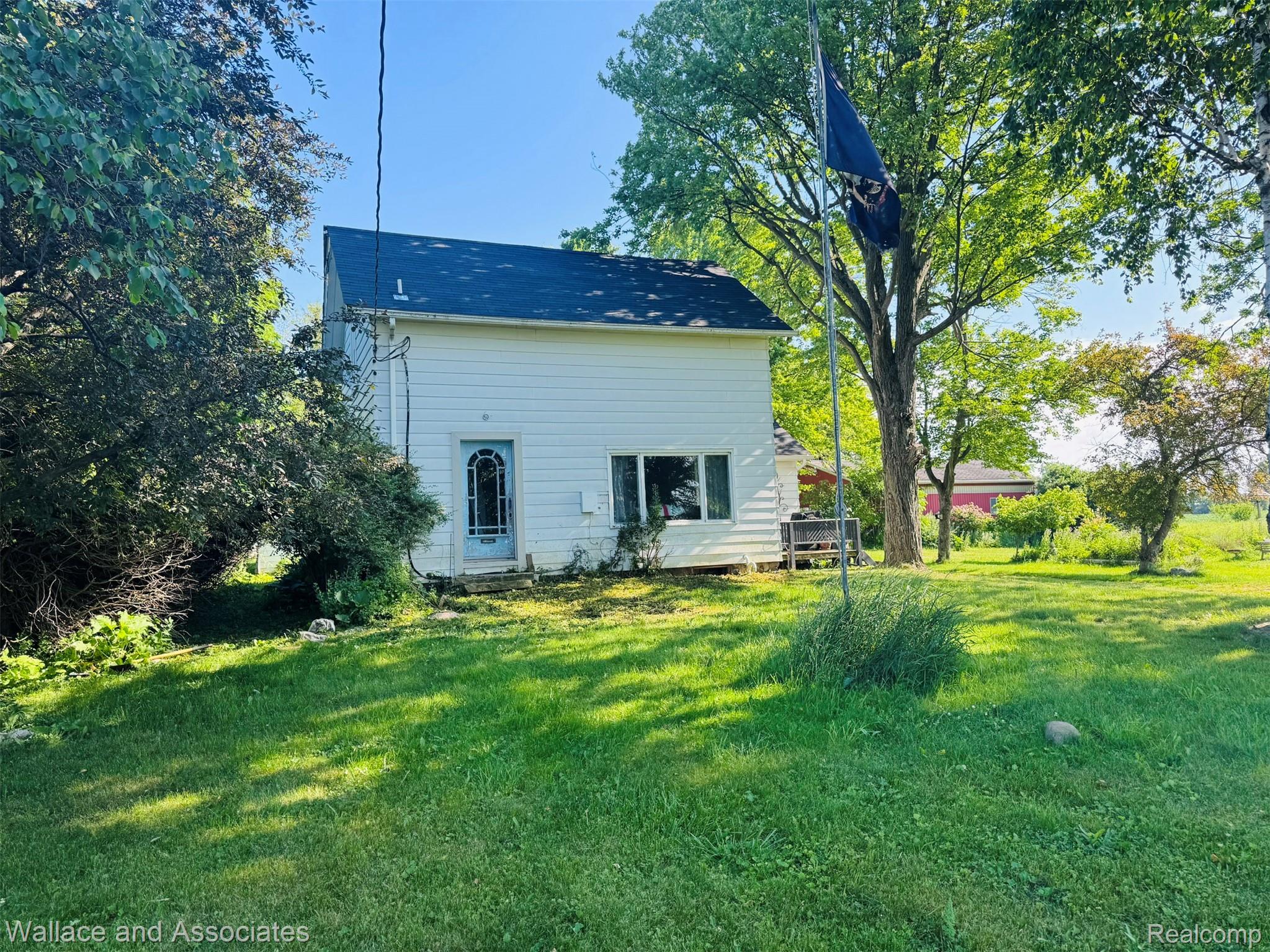 5949 Roach Road Croswell, MI 48422 - Photo 2 of 48 Two-story residence with white siding and a dark roof