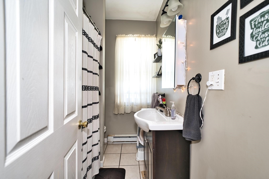 232 Alden Street Fall River, MA 02723 - Photo 20 of 34 a bathroom with a sink a mirror and a window