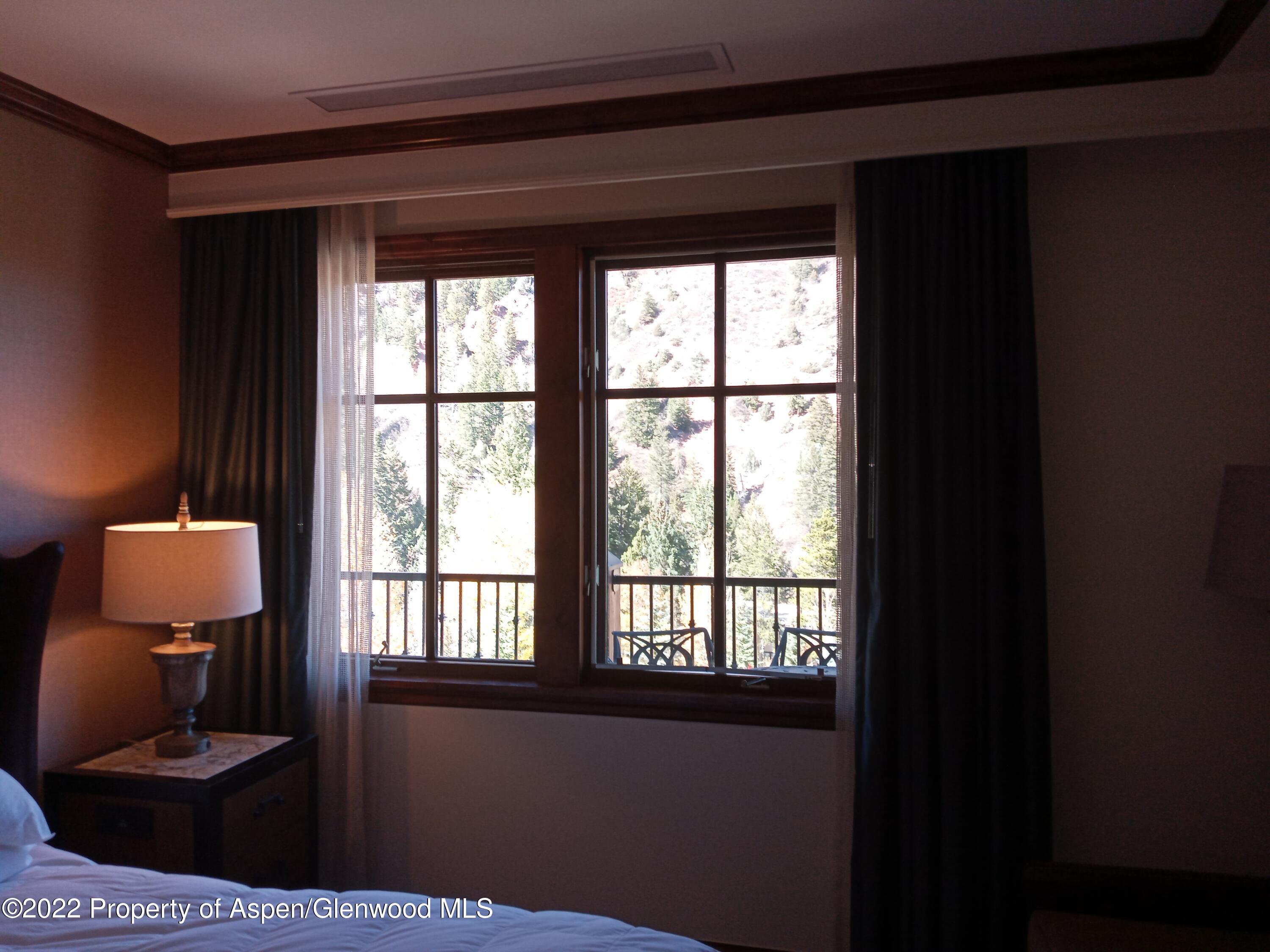 39 Boomerang Road, Unit 8412 SUMMER Aspen, CO 81611 - Photo 14 of 21 a living room with furniture and a window