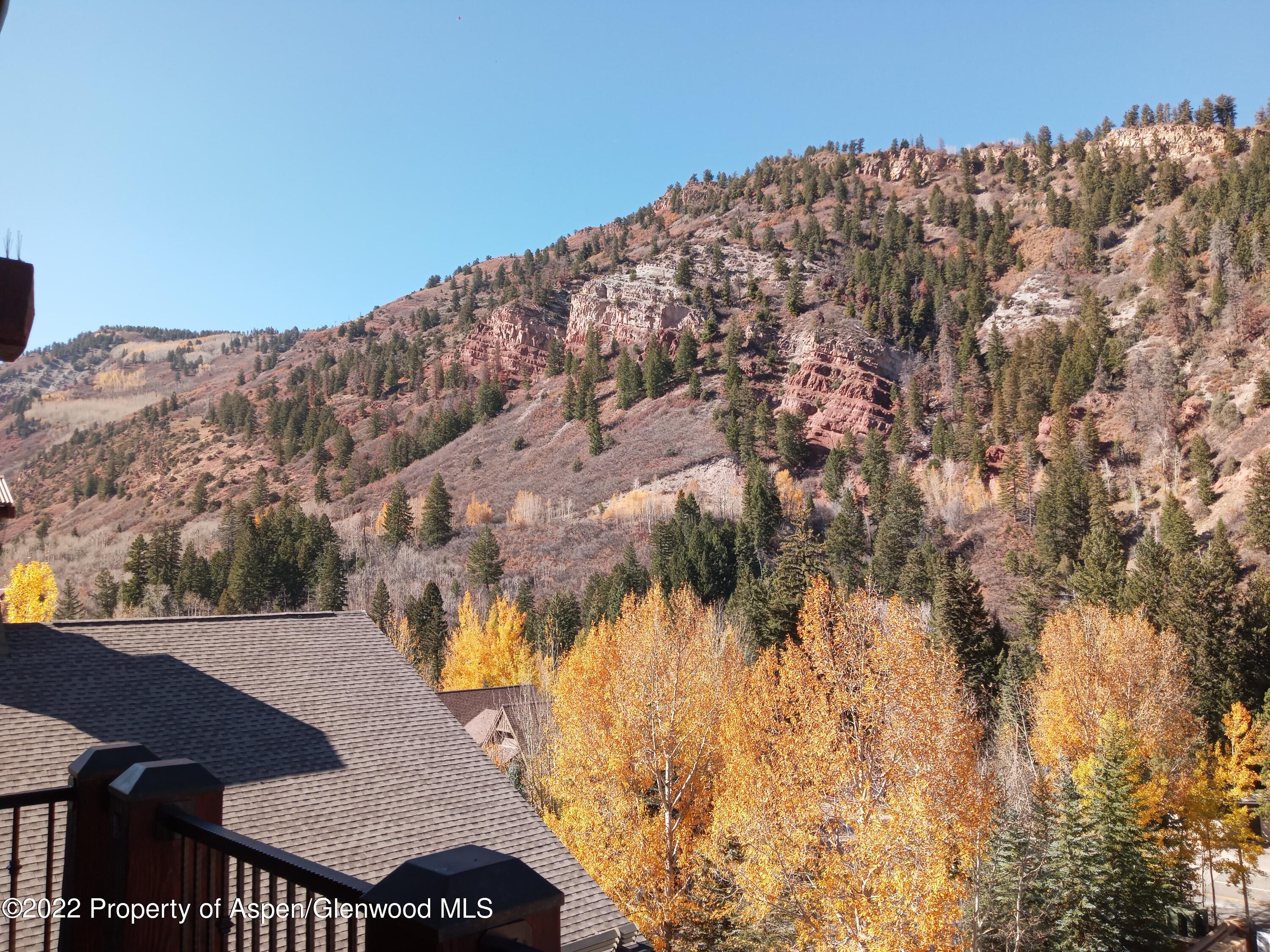 39 Boomerang Road, Unit 8412 SUMMER Aspen, CO 81611 - Photo 18 of 21 a view of a large building with mountains in the background