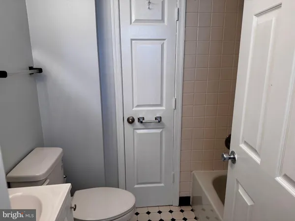 a white toilet sitting next to a bathroom sink