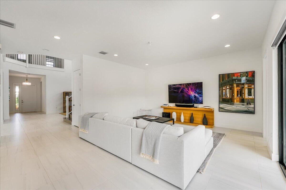 17496 Sparkling River Road Boca Raton, FL 33496 - Photo 15 of 36 a living room with furniture and a flat screen tv