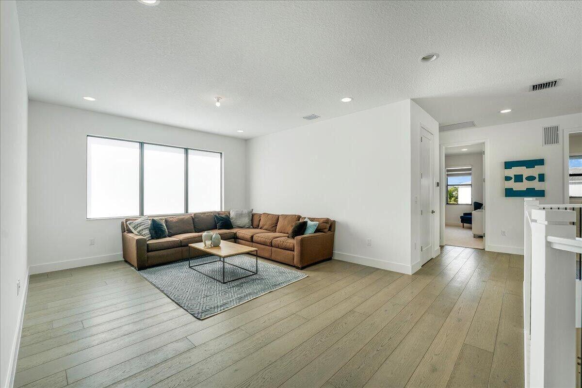 17496 Sparkling River Road Boca Raton, FL 33496 - Photo 17 of 36 a living room with furniture and a wooden floor