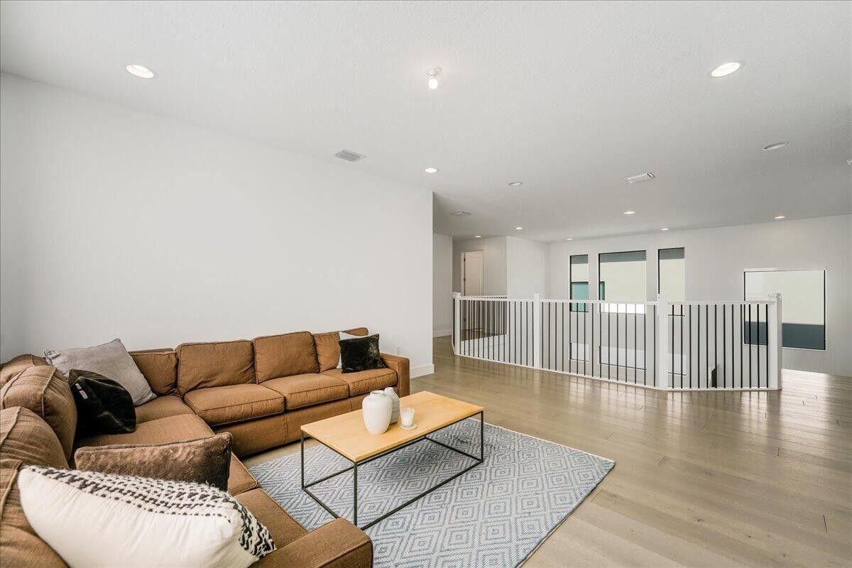 17496 Sparkling River Road Boca Raton, FL 33496 - Photo 18 of 36 a living room with furniture and a wooden floor