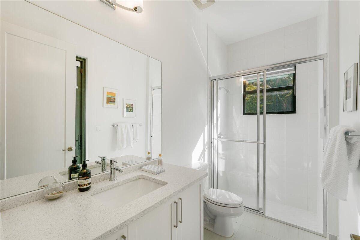 17496 Sparkling River Road Boca Raton, FL 33496 - Photo 23 of 36 a bathroom with a toilet sink and mirror