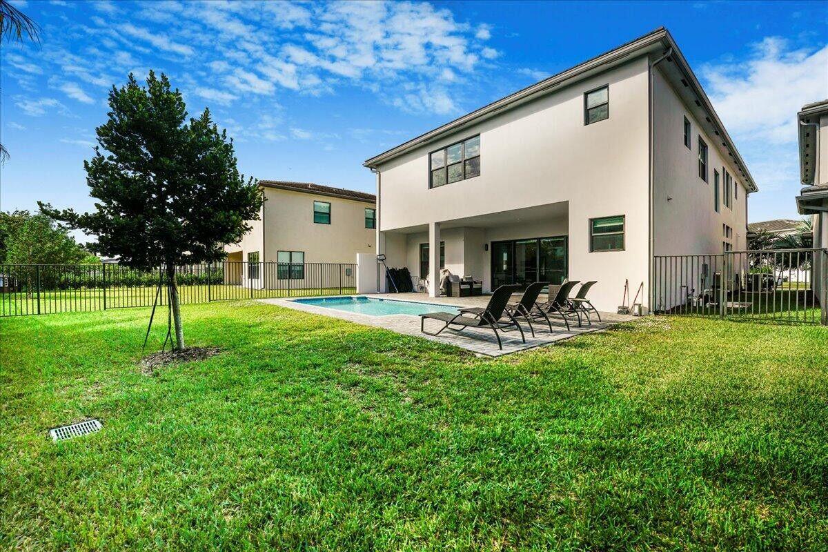 17496 Sparkling River Road Boca Raton, FL 33496 - Photo 30 of 36 a view of a patio with a table chairs and a fire pit