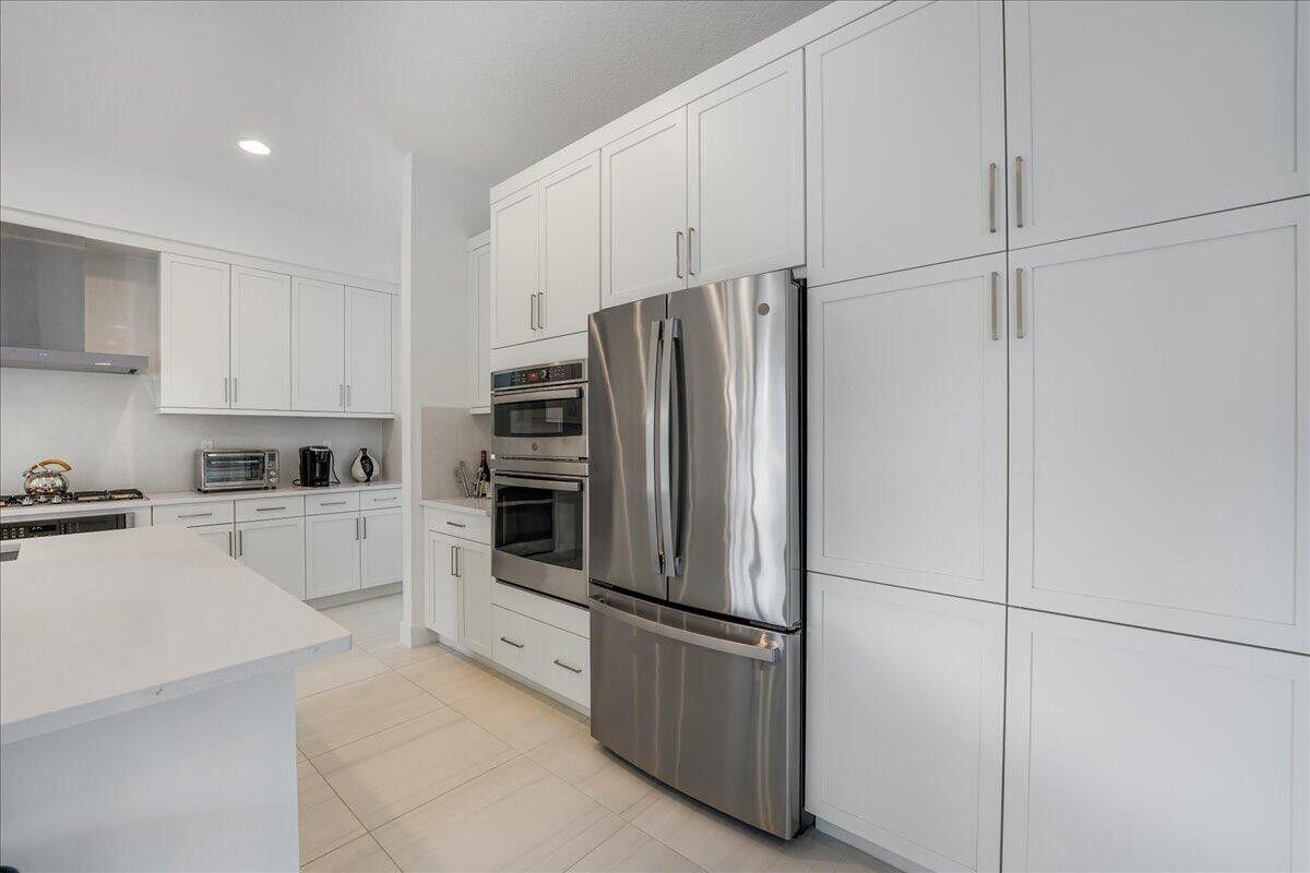 17496 Sparkling River Road Boca Raton, FL 33496 - Photo 6 of 36 a kitchen with cabinets and stainless steel appliances