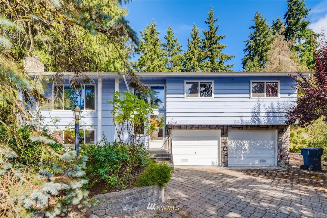 1823 224th Street Southwest Bothell, WA 98021 - Photo 1 of 27 a front view of a house with a garden