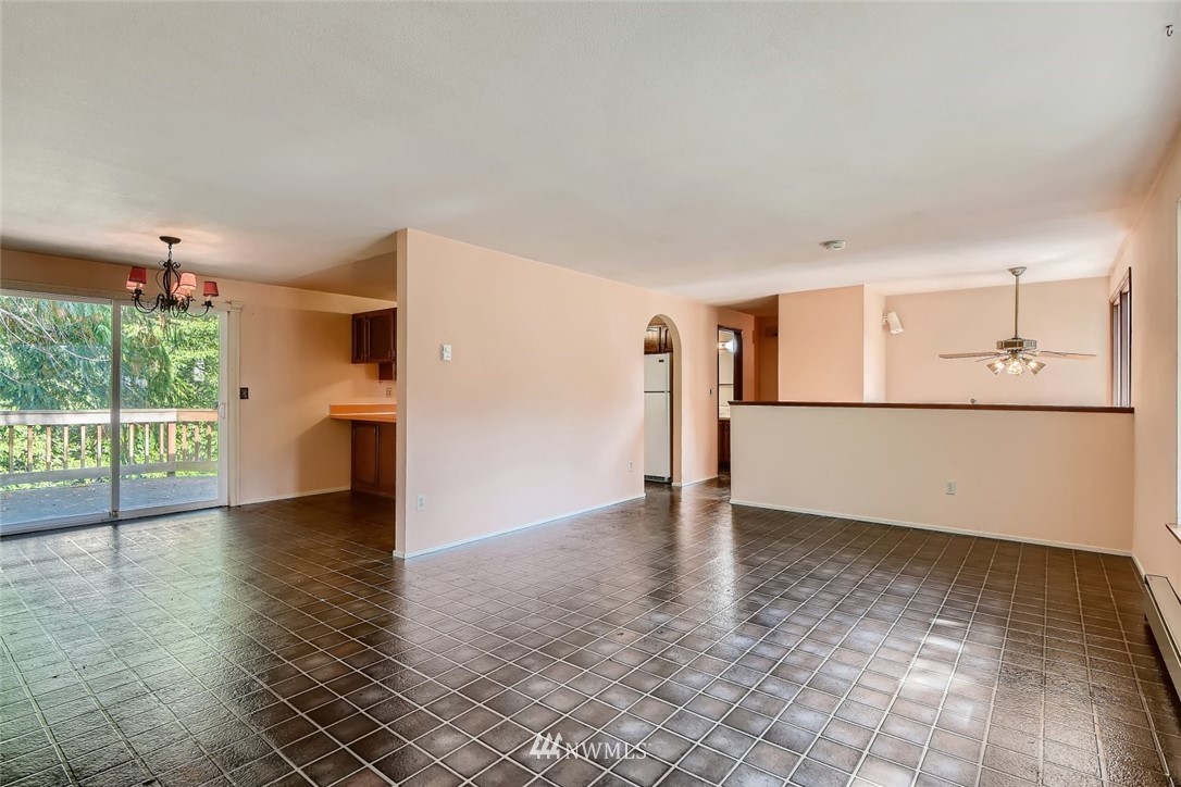 1823 224th Street Southwest Bothell, WA 98021 - Photo 14 of 27 a view of empty room with wooden floor and fireplace