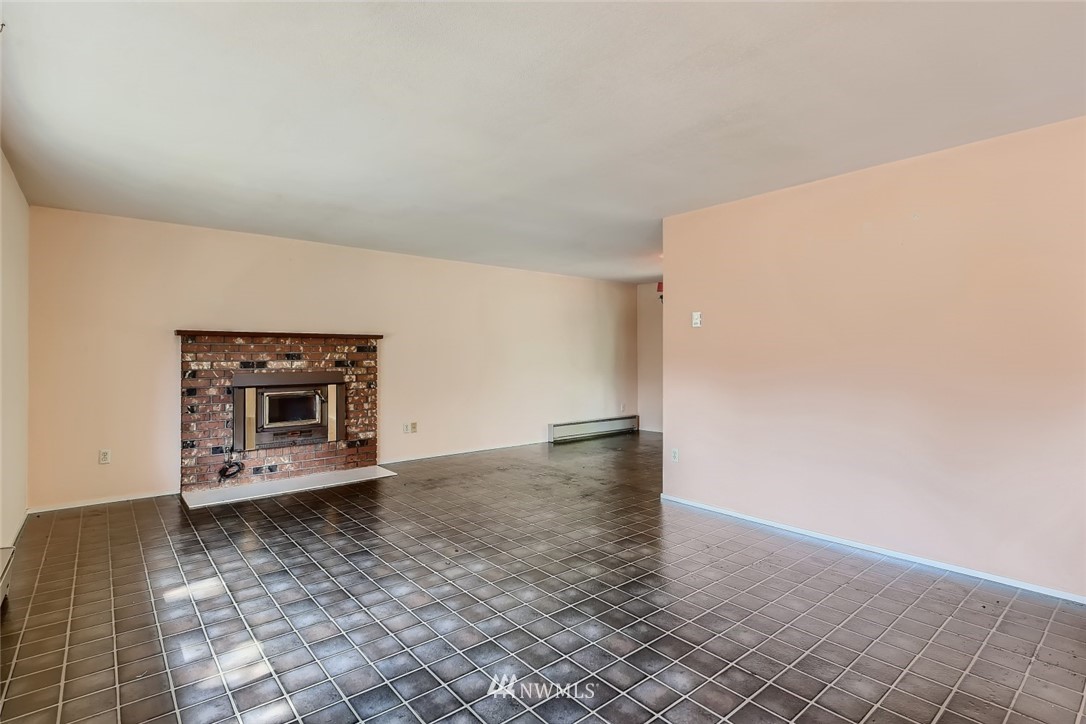 1823 224th Street Southwest Bothell, WA 98021 - Photo 15 of 27 an empty room with a fireplace and a window