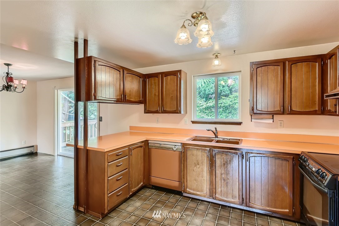 1823 224th Street Southwest Bothell, WA 98021 - Photo 18 of 27 a kitchen that has a sink and cabinets
