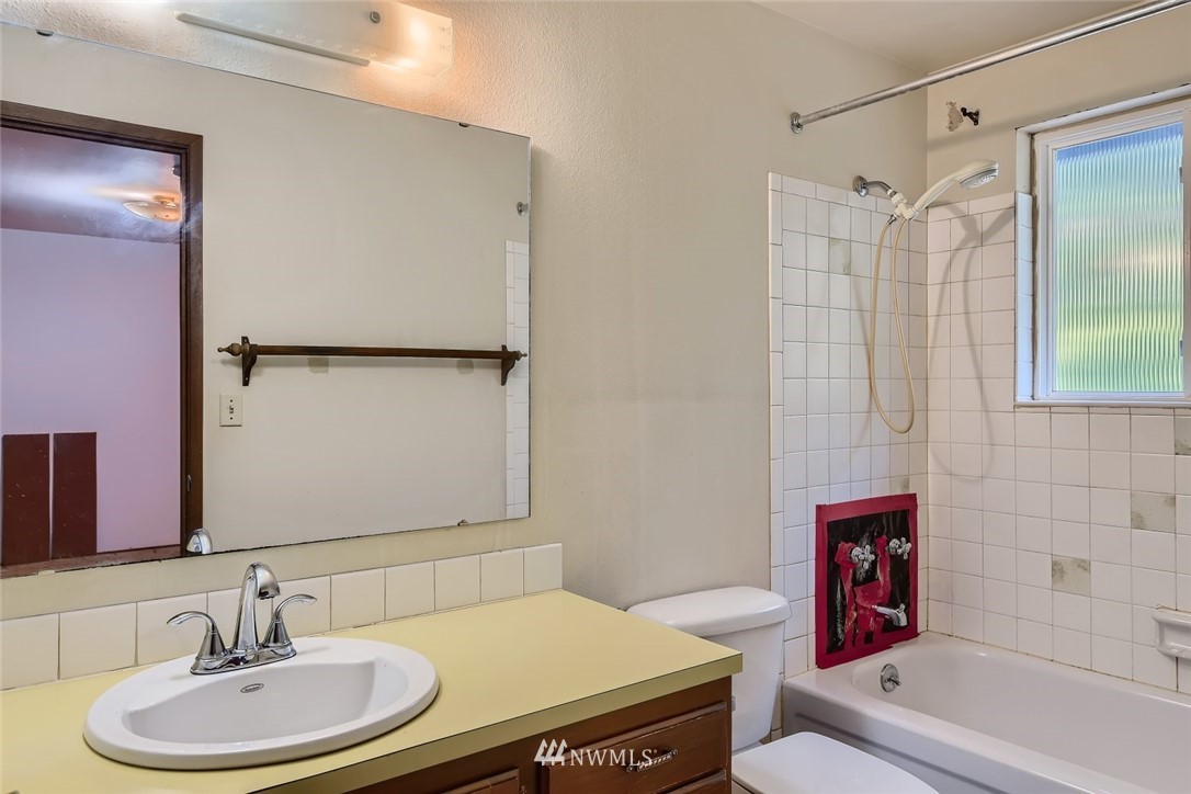 1823 224th Street Southwest Bothell, WA 98021 - Photo 20 of 27 a bathroom with a granite countertop sink toilet a mirror and shower