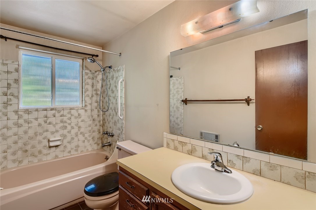 1823 224th Street Southwest Bothell, WA 98021 - Photo 23 of 27 a bathroom with a sink a toilet a mirror and shower