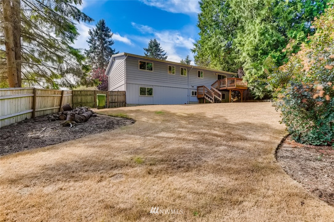 1823 224th Street Southwest Bothell, WA 98021 - Photo 7 of 27 a front view of a house with a yard and garage