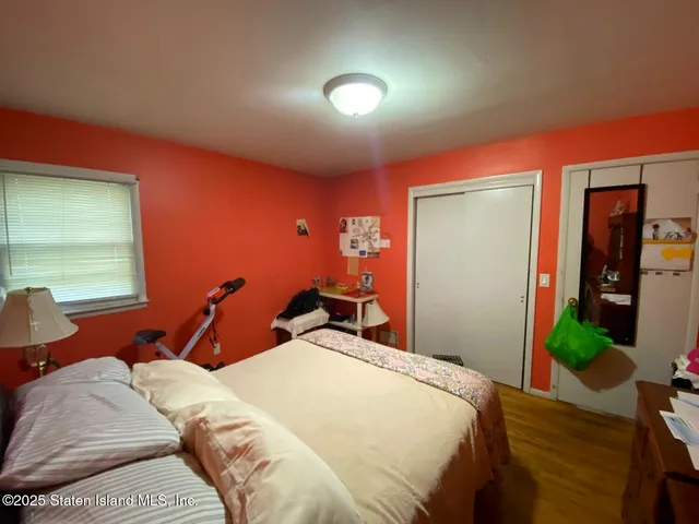 a bedroom with a bed and a windows