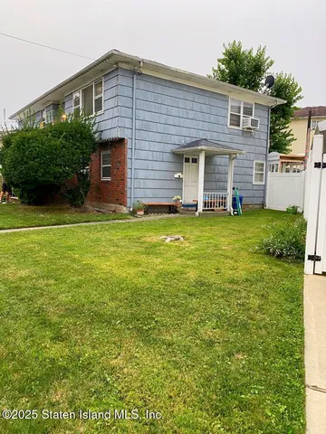 a kitchen with a refrigerator a stove a sink and white cabinets