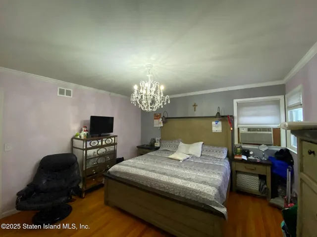 a bedroom with a bed and a flat tv screen