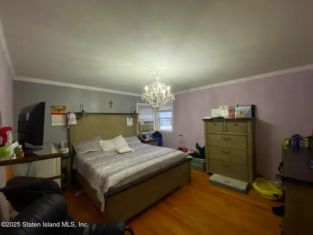 a bed room with a bed and a dresser