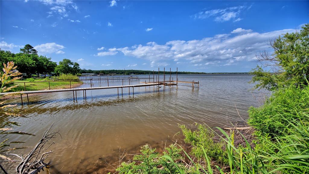 140 Elm Road Nocona, TX 76255 - Photo 24 of 26 a view of a swimming pool with a yard