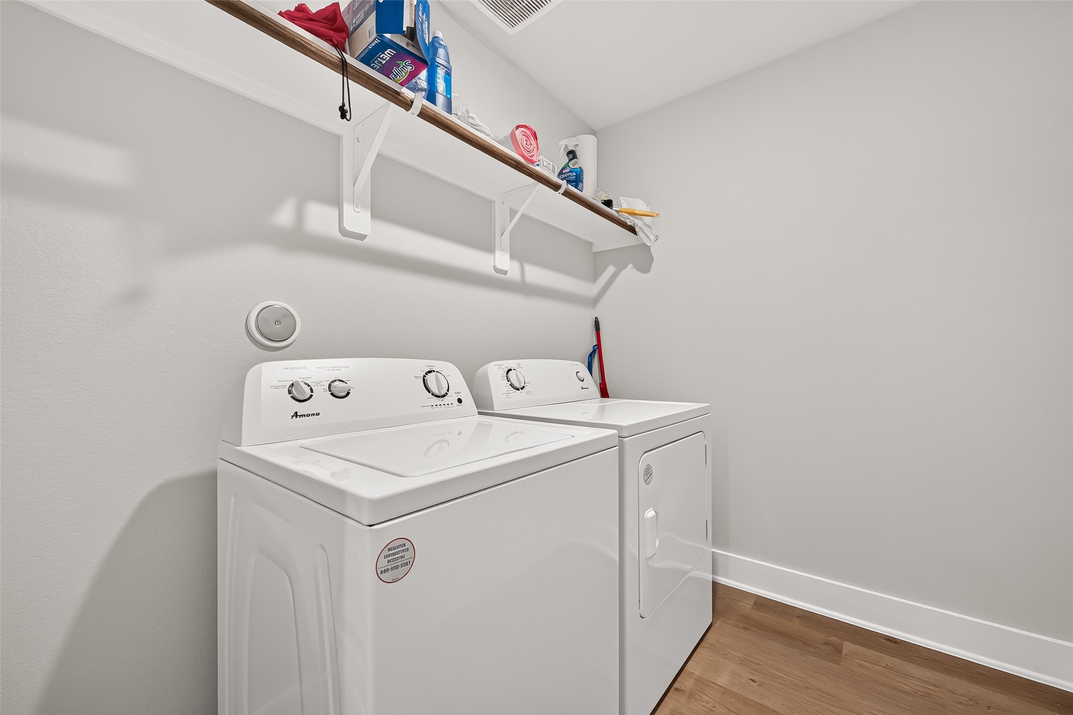 4004 Baja Lane Houston, TX 77045 - Photo 30 of 34 A pristine and practical utility space. This highly functional laundry room features a modern washer and dryer set included with the property. With clean neutral walls and a convenient built-in upper shelf for easy storage, this space is beautifully optimized and ready for use.