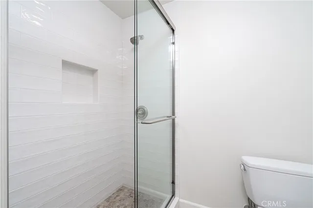 a bathroom with a toilet and a shower