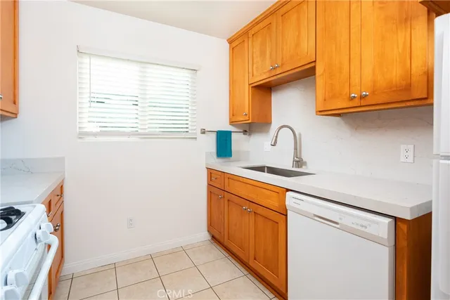 a kitchen with stainless steel appliances granite countertop a sink and a stove