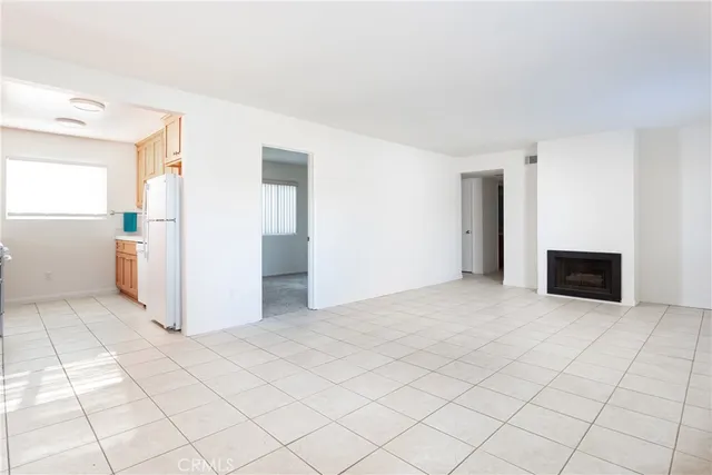 a view of a livingroom with an empty space and a fireplace