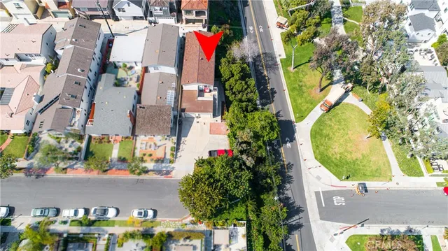 an aerial view of residential houses with outdoor space and street view