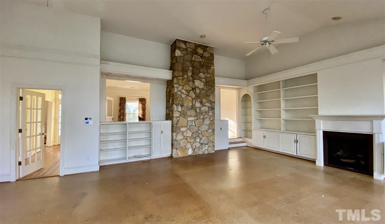 wooden floor in an empty room with a fireplace