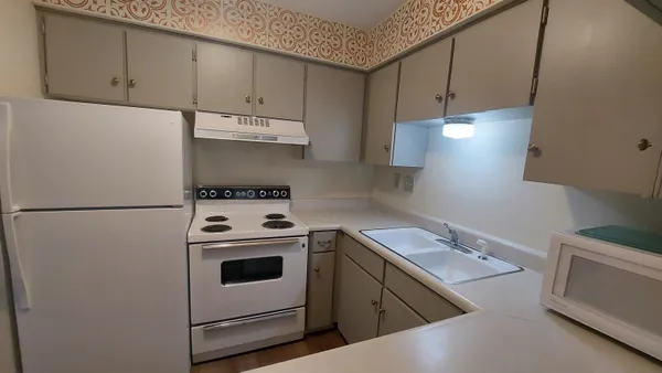 a kitchen with a sink a stove and refrigerator