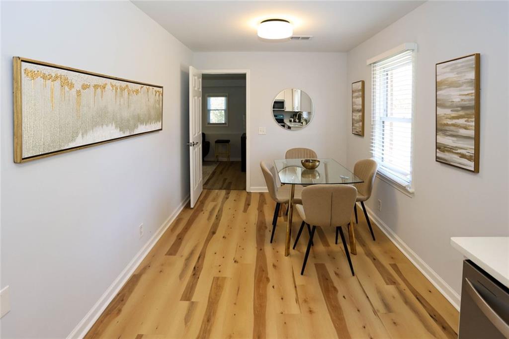 1745 Rockbridge Road Northwest Conyers, GA 30012 - Photo 13 of 46 a view of a dining room with furniture and wooden floor