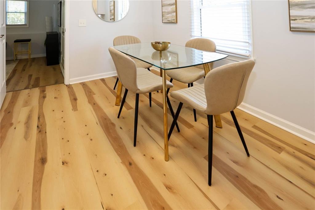 1745 Rockbridge Road Northwest Conyers, GA 30012 - Photo 14 of 46 a dining room with furniture and wooden floor
