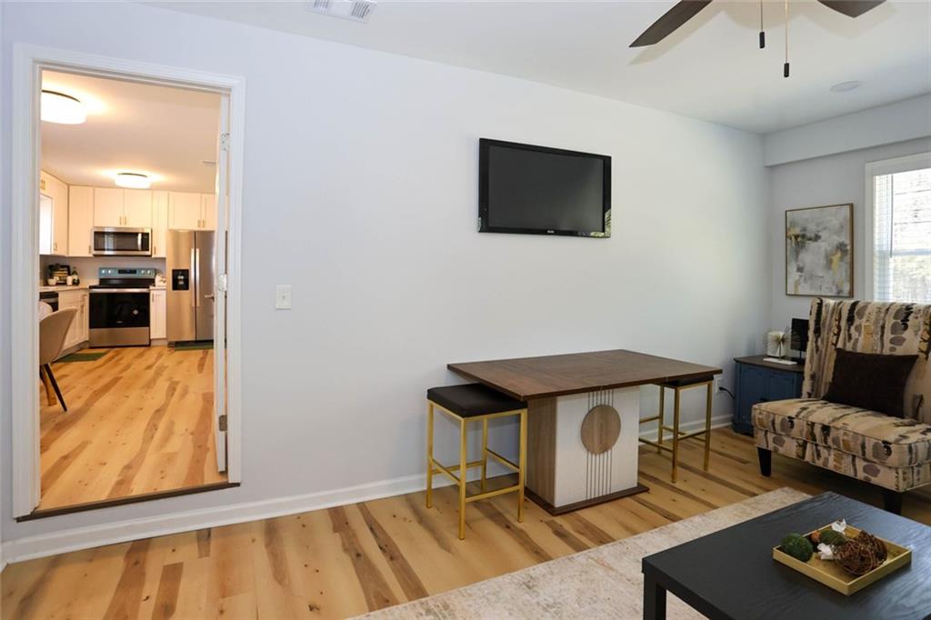 1745 Rockbridge Road Northwest Conyers, GA 30012 - Photo 15 of 46 a view of a livingroom with furniture and a flat screen tv