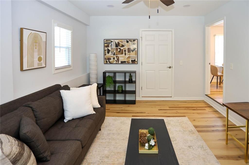 1745 Rockbridge Road Northwest Conyers, GA 30012 - Photo 20 of 46 a living room with furniture and painting on the wall