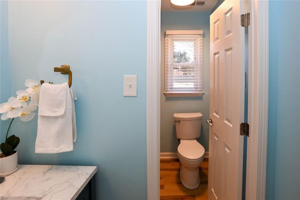 1745 Rockbridge Road Northwest Conyers, GA 30012 - Photo 21 of 46 a bathroom with a toilet and a shower curtain